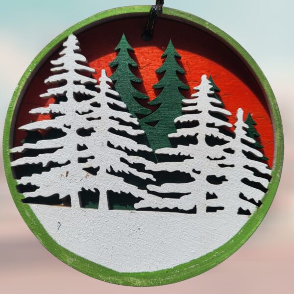 White and Green Pine Trees Winter Scene Red Background Wood Layered Ornament